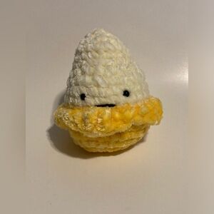 Hand crocheted mini banana plushie.